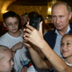 A girl takes a self portrait with Russian President Vladimir Putin as he vists a sports center for children in the Black Sea resort of Sochi, Russia, Saturday, Oct. 11, 2014.